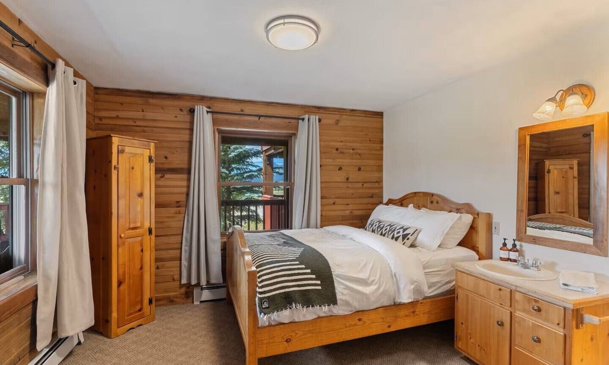 Clark Cabin | Comfortable private queen room in the True North Adventure Lodge. Includes a queen bed, private ensuite bathroom, and access to shared amenities like the kitchen, great room, and hot tub. Great for couples or solo travelers.