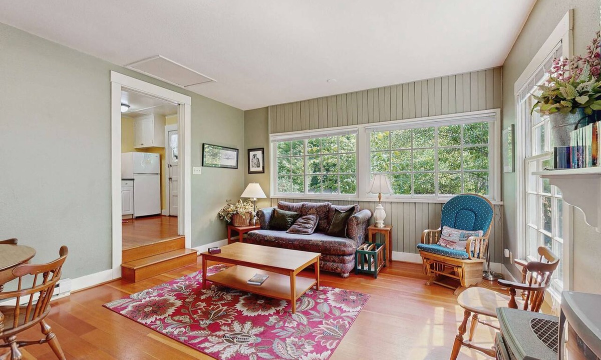 Molalla House | Tranquil landscape with riverside firepit, gas grill, gas fireplace, and deck