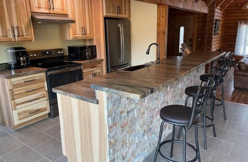 Flagstaff House | Cheerful Cabin with large stone patio and hot tub, next to trails!