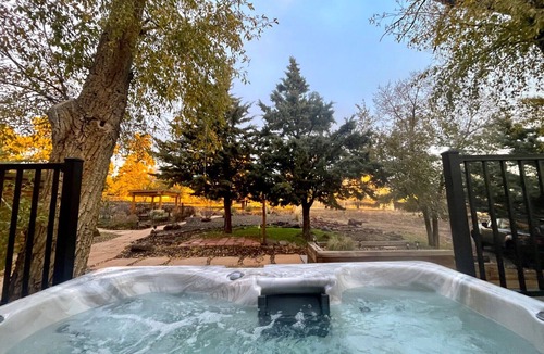 Flagstaff House | Cheerful Cabin with large stone patio and hot tub, next to trails!
