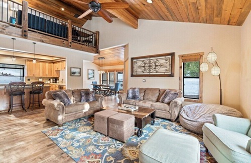 Shaver Lake House | Luxury Shaver Lake retreat with pond views, soaring wood ceilings, a stone fireplace, gourmet kitchen, four bedrooms, a loft, spacious backyard, and a brand-new spa. Perfect for families and groups seeking a mountain getaway.