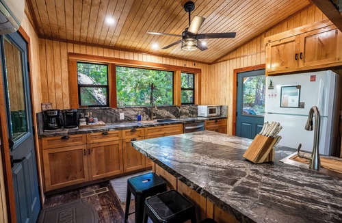 Sierra Cedars Cabin | Tucked in the trees, Cedar Hill is a cozy A-frame cabin with modern updates, a spacious kitchen, wraparound deck, and stunning views. The perfect mountain escape for families, couples, and friends—plus, it's pet-friendly!