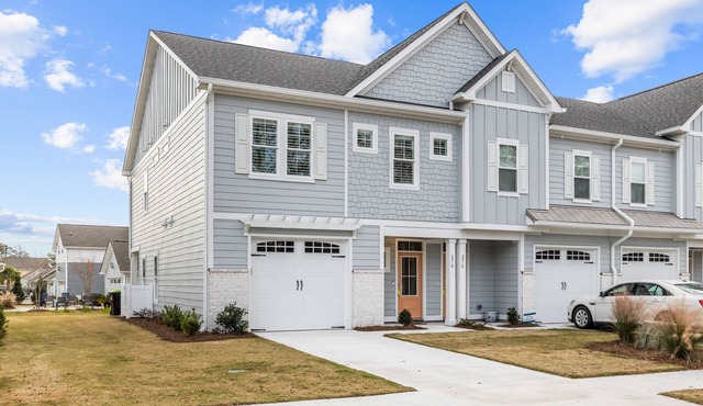 Coastal townhome with outdoor living, central AC, washer/dryer, & pool access