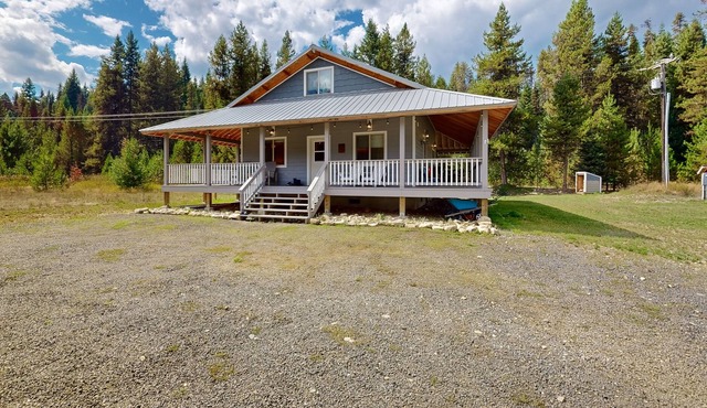 Dog-friendly riverfront home near town with deck, water views, & fireplace