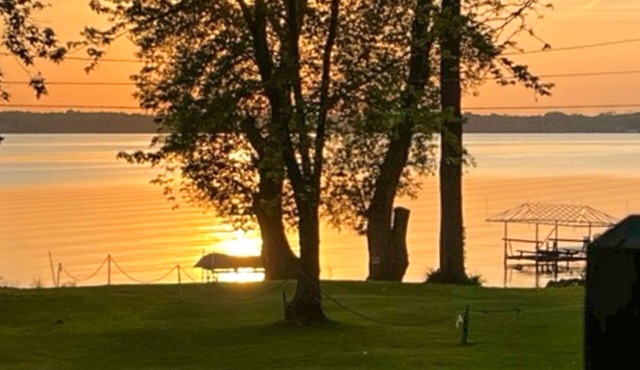 Lake-view retreat with dock access, firepits, & large yard