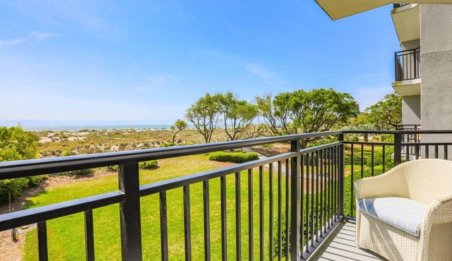 Professionally Decorated Corner Condo with Ocean Views, Covered Balcony & Access to Community Pool