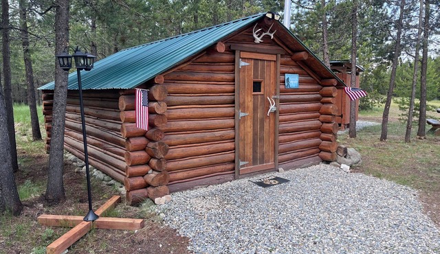 Retreat to our cozy cabin nestled in a private hideaway. Solar lights & shower