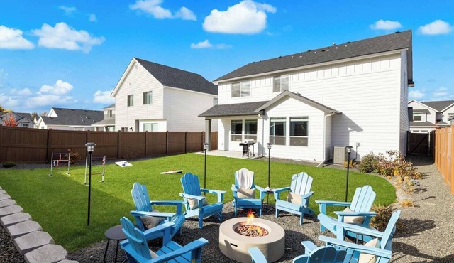 This 5-bedroom home has it all—gas fire pit for 8, hot tub, cornhole, ladder golf, ping pong, and a gas grill. Inside, enjoy a rock climbing wall, office desk, and a garage gym.